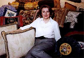 Charlotte Crystal, surrounded by her unique cushions
